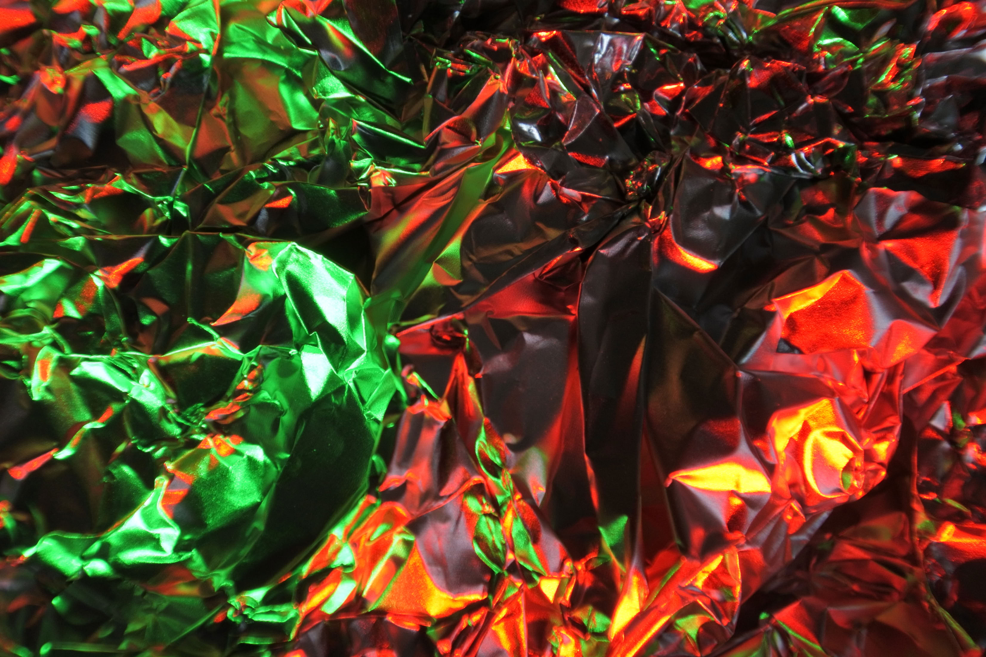 Crinkled foil with green and red reflections.