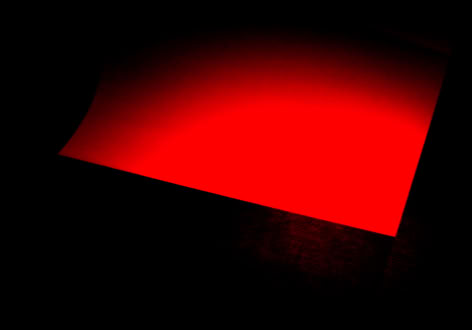 A red rectangular light source against a dark background.
